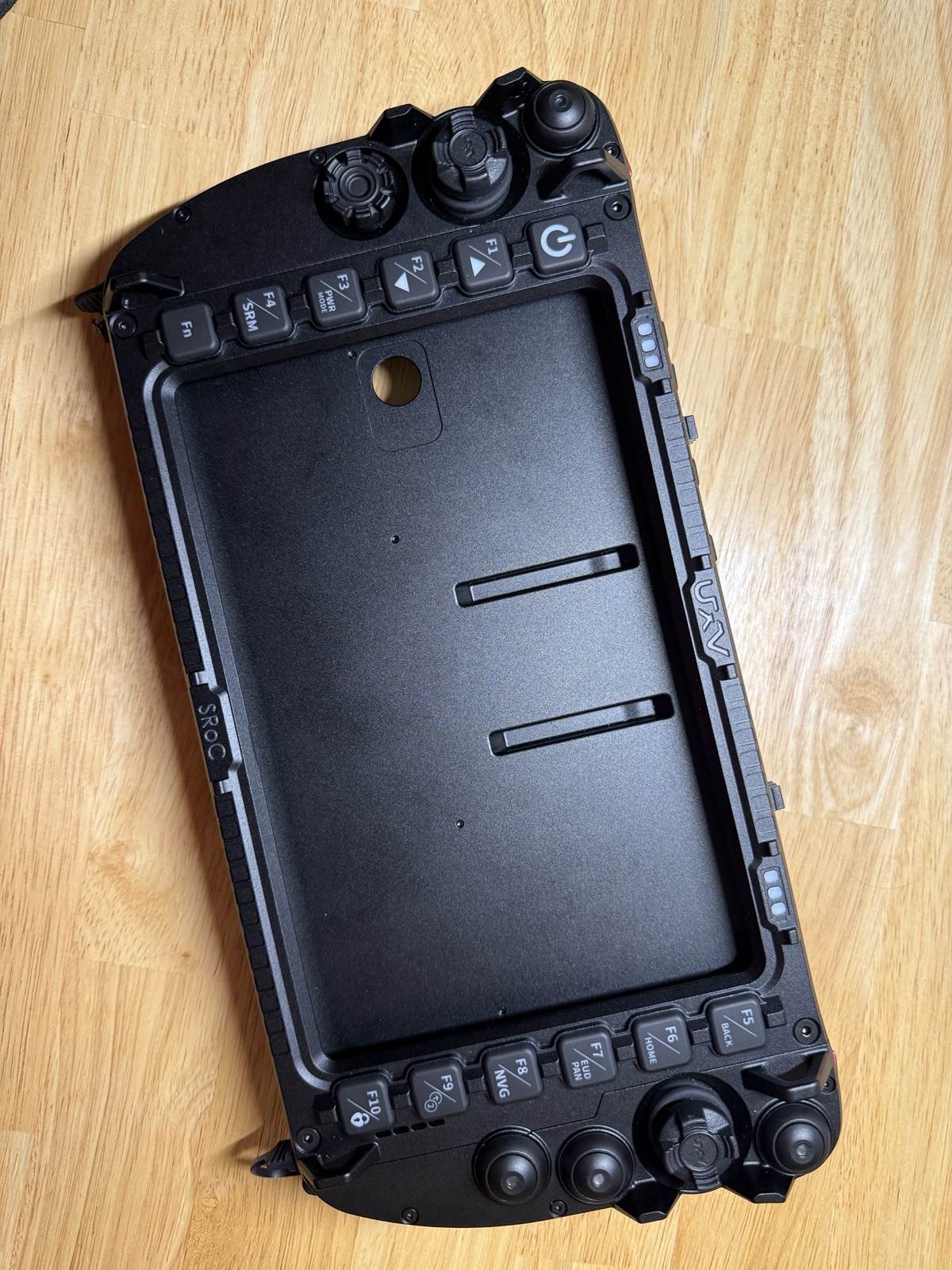 SRoC controller rear shell with the tablet cavity empty and the front bezel not yet attached, showing the F1–F4 buttons and control dials at top and the F5–F10 buttons and joysticks at bottom