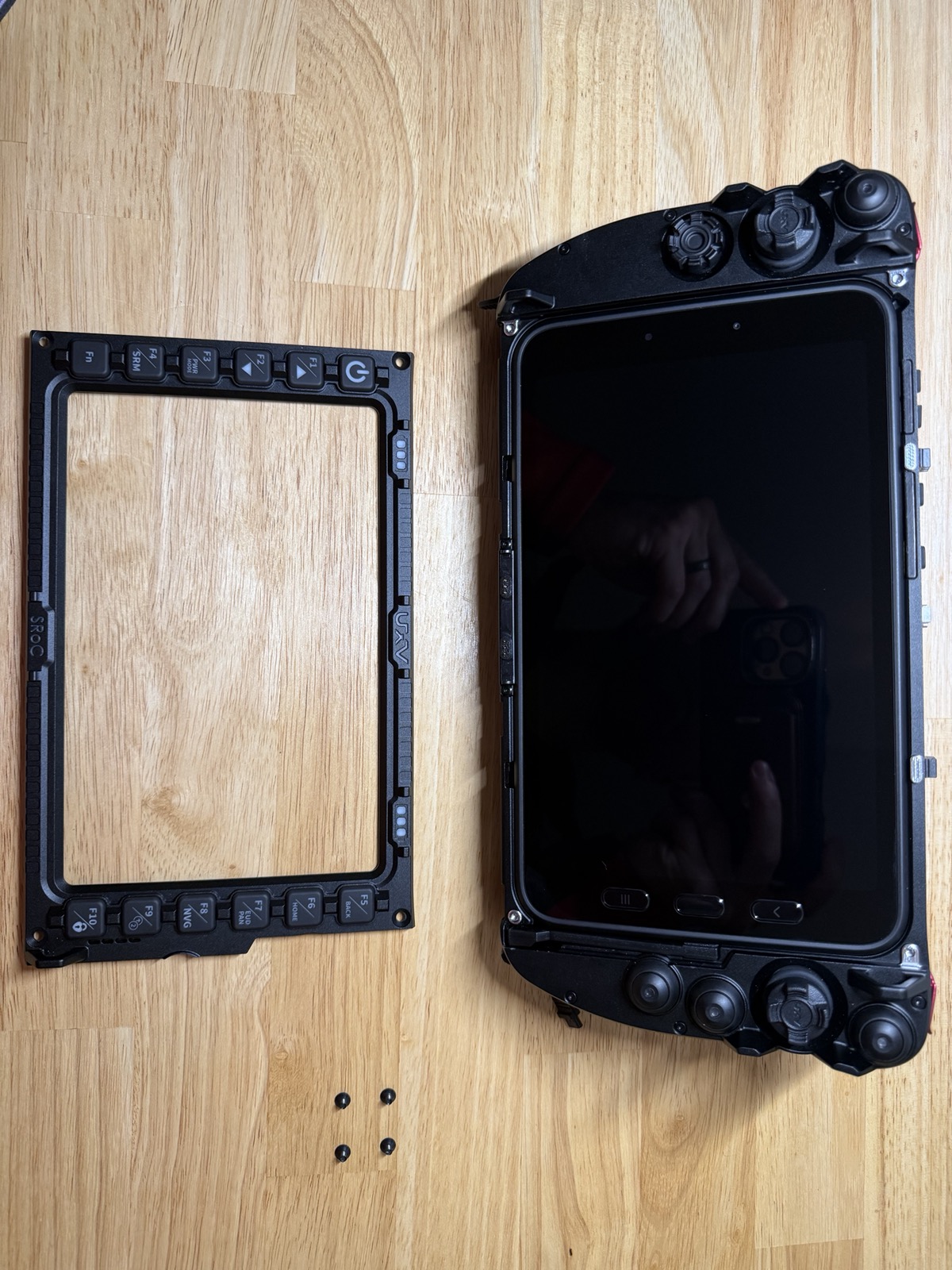 Tab 5 tablet seated in the housing with the front bezel not yet reattached, screen off