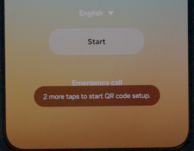 Welcome screen showing a "2 more taps to start QR code setup" hint in place of Emergency call